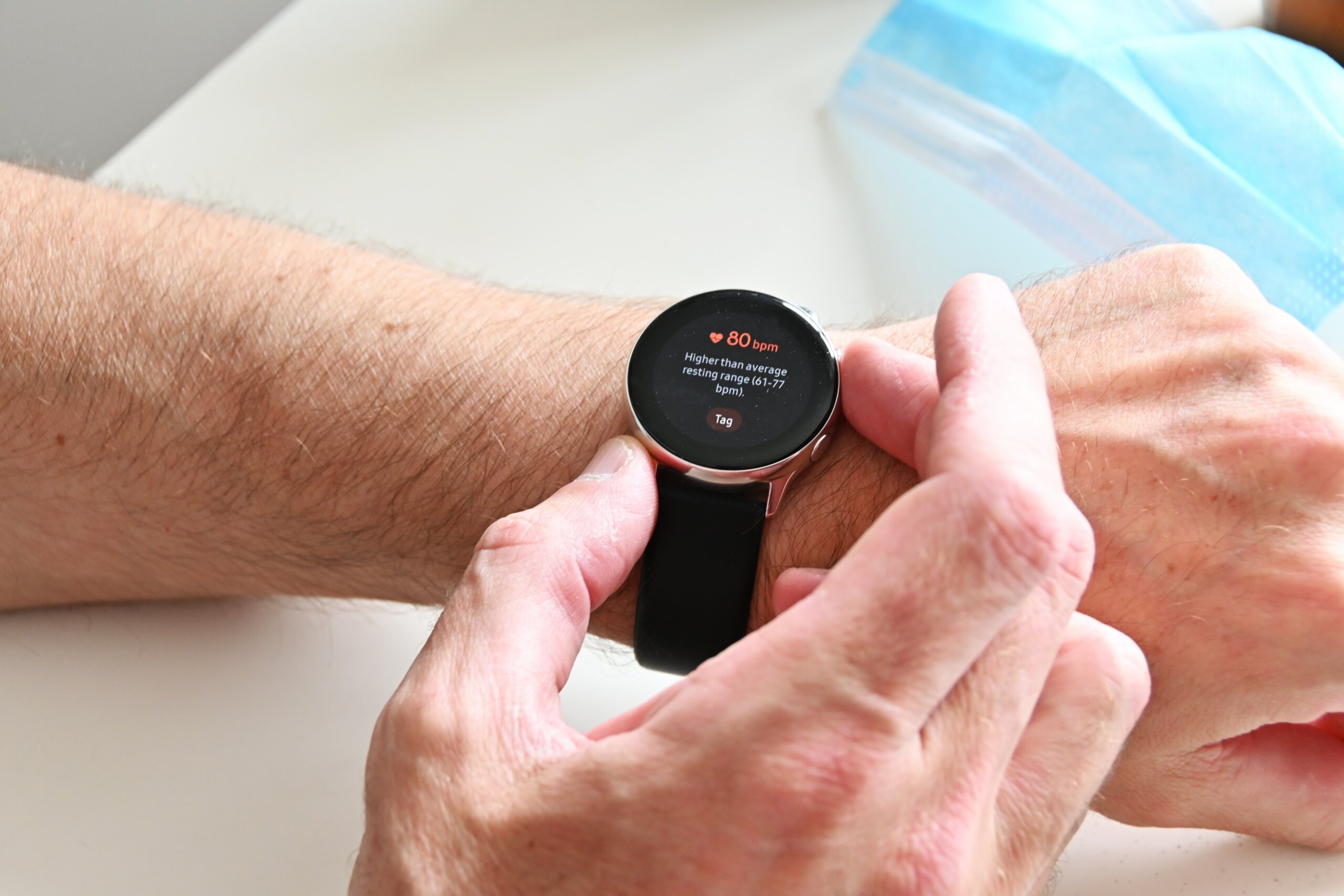 Close-up of a mans smart watch with heart rate monitor