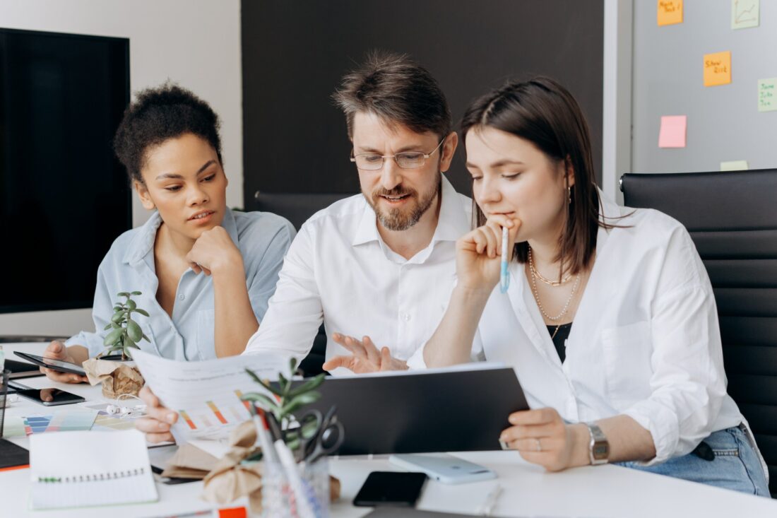 Team members in a board room reviewing data togther